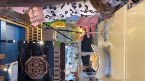 Cropped side view of Young pleasant happy Caucasian woman sitting in cafe Stock Footage 265016400