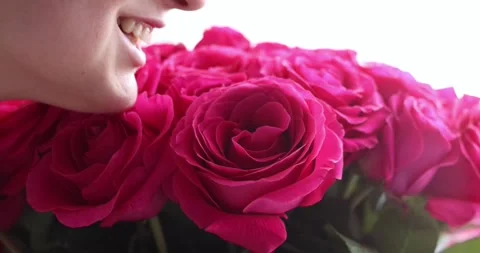 Cropped smiling face lips close-up happy woman hand holding big bouquet of re Stock Footage 300365718