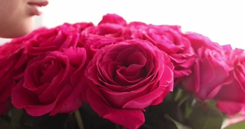 Cropped smiling face lips close-up happy woman hand holding big bouquet of re Stock Footage 300365736