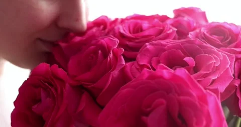 Cropped smiling face lips close-up happy woman hand holding big bouquet of re Stock Footage 300365737
