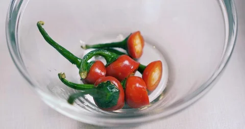 Cropped Stalk Of Fresh Hot Red Pepper In A Glass Container. Spicy Food Or Dish Stock Footage 128096344