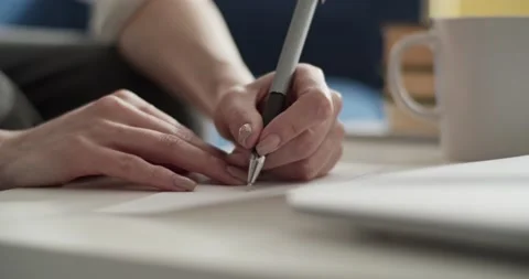 Cropped student taking notes in notebook at home Stock Footage 172142654
