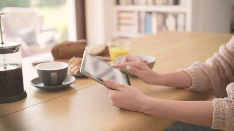 Cropped video of woman using digital tablet at breakfast table Stock Footage 79659175