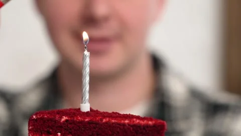 Cropped view of 30s man holding birthday cake with burning candles blowing party Stock Footage 262004155