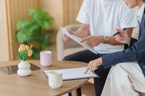 Cropped view of advisor and client signing contract agreement during Stock Photos