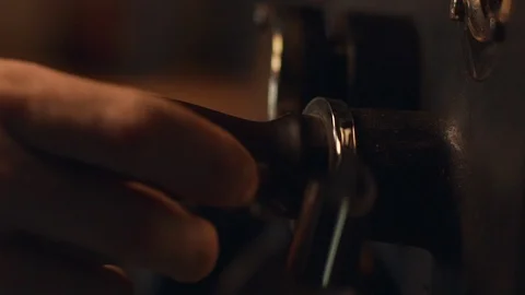 Cropped view of barista guy roasting coffee beans in special old machine, in Stock Footage 91549258
