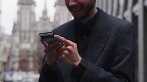 Cropped view of a bearded man who stands on the street and taps on the Stock Footage 238833372