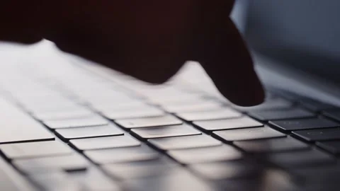 Cropped view of hands typing on laptop keyboard. The man quickly types Stock Footage 236643748