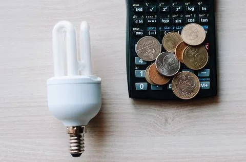 Cropped view  led and fluorescent lamps next to calculator in hands isolated  Stock Photos