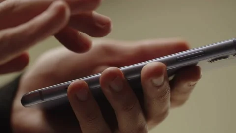 Cropped view of male hands tapping on smartphone screen. A man looks through Stock Footage 236302966