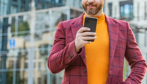 Cropped view of man messaging on smartphone outside. photo of man messaging on Stock Photos