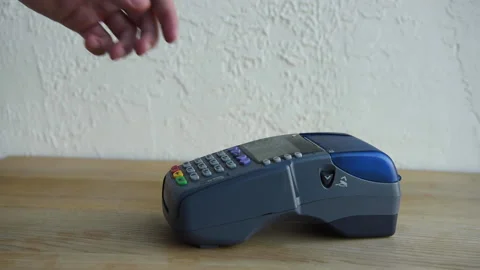 Cropped view of man pushing buttons on payment terminal while using credit card 库存影片 133781036