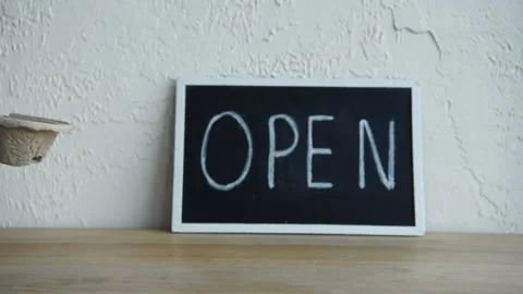 Cropped view of man putting coffee to go near open signboard Stock-Footage 133781727