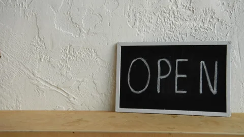 Cropped view of man putting disposable cup near open signboard Stock-Footage 133780750
