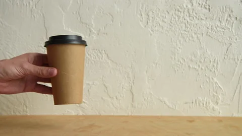 Cropped view of man putting disposable cups on wooden surface Stock-Footage 133780932