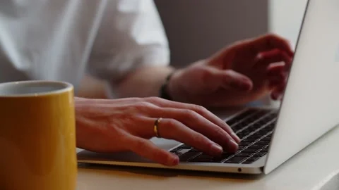 Cropped view of a man remotely working on a laptop from a cafe. A man is Stock Footage 236564033