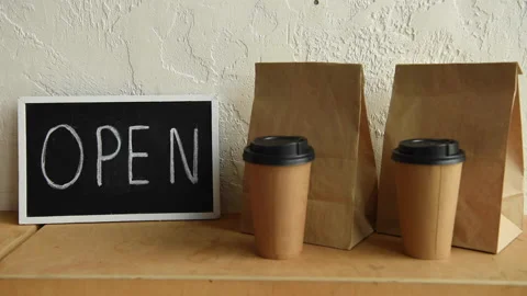 Cropped view of man showing thumb up near open signboard, takeaway package Stock-Footage 133780238