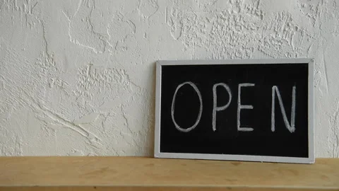 Cropped view of man showing thumb up near open signboard 库存影片 133781443