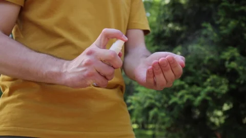 Cropped view of man spraying hand sanitizer on hand 库存影片 136113807
