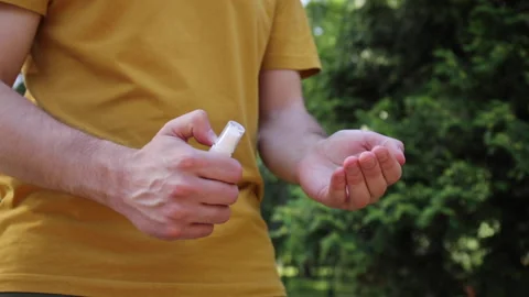 Cropped view of man spraying hand sanitizer on hand Stock Footage 136114057