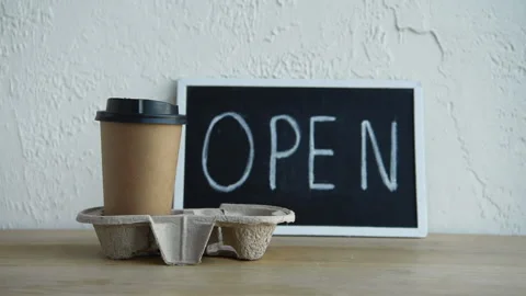 Cropped view of man taking coffee to go near open signboard Stock-Footage 133780471