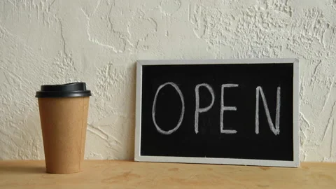 Cropped view of man taking disposable cup near open signboard, showing thumb up Stock-Footage 133783269