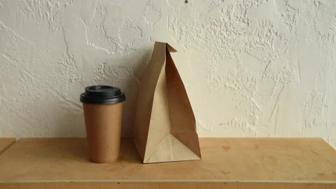 Cropped view of man taking paper bag and disposable cup Stock-Footage 133780386
