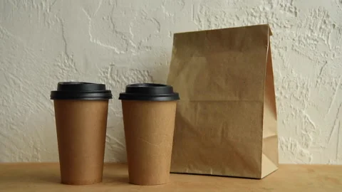Cropped view of man taking paper bag and disposable cups Stock-Footage 133783656