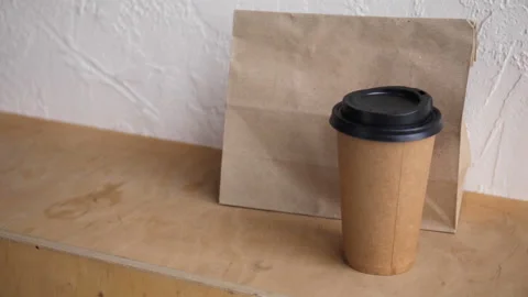 Cropped view of man using payment terminal near paper bag and cup Stock-Footage 132446277