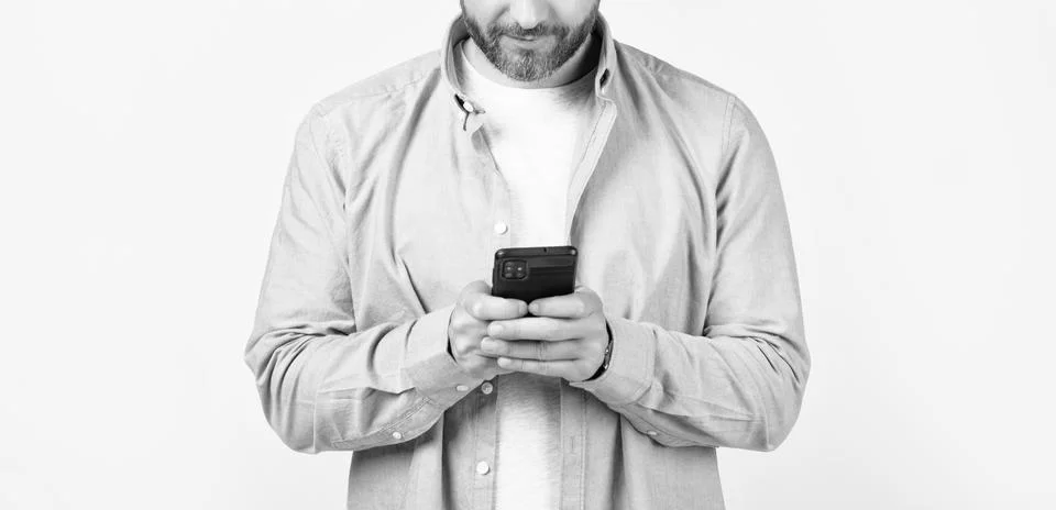 Cropped view of man write message on phone isolated on studio background. Stock Photos