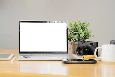 Cropped view of notebook with white screen at photographer workspace. Stock Photos