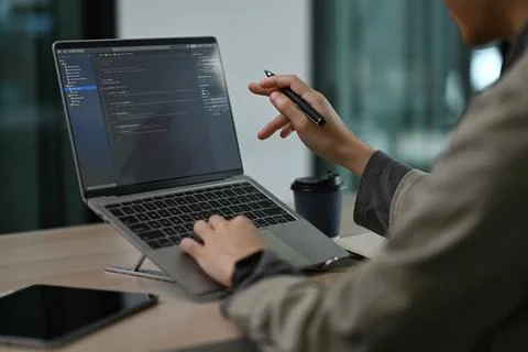 Cropped view of professional software developer working with coded data in Foto stock