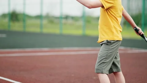 Cropped view unrecognizable boy playing pickleball game, hitting pickleball Stock-Footage 244049544