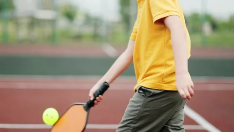 Cropped view unrecognizable boy playing pickleball game, hitting pickleball Stock-Footage 244171207