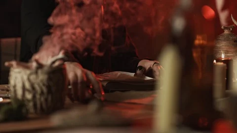 Cropped view of witch touching pentagram with knife during occult ritual Stock Footage 125023539