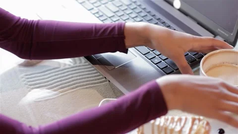 Cropped view of a woman's hands typing on a laptop Video stock 311189614