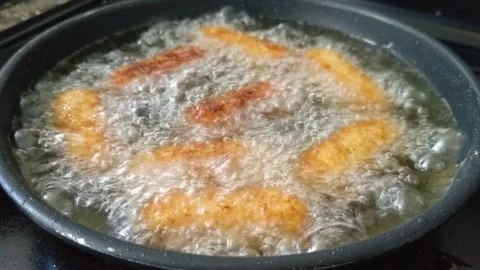 Croquettes frying in a pan Stock Footage 219589267