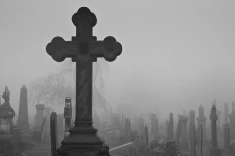 A cross in ancient an graveyard Stock Photos