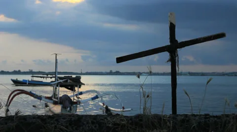 A Cross and a Boat at Dusk Stock Footage 37450962
