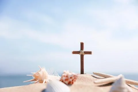 Cross and conch shell on the beach, summer retreat and summer camp background Stock Photos