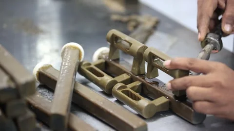Cross angle shot of man is casting joint a part in factory, industrial safety Stock Footage 297194883