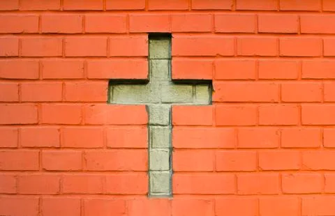 Cross between bricks Stock Photos