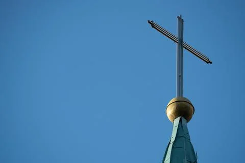 The cross on the blue clear sky background. 库存照片