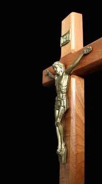 Cross with body of Christ on solid black background 写真素材