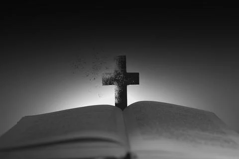 Cross with a book on the table Stock Photos
