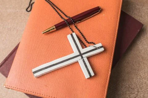 Cross on a books. Stock Photos