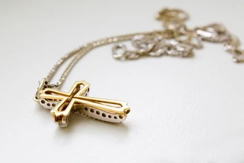 Cross on a chain on white background Stock Photos