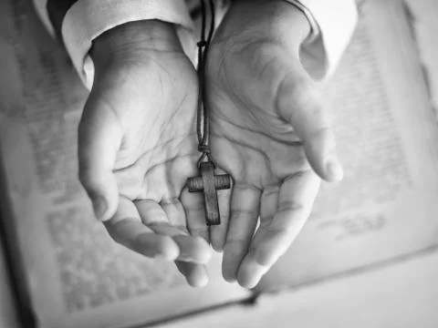 Cross in the child's hand. Stock Photos