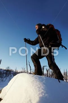Cross-Country Skier Walking In Snow