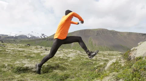 Cross country trail run jumping running man - Fit male runner exercising Stock Footage